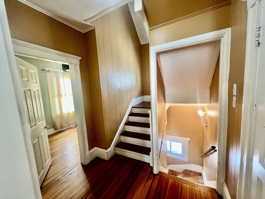 41 Pearl Street, Unit 2 Everett, MA 02149 - Photo 10 of 26 a view of front door with wooden floor and stairs