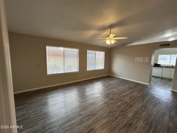 wooden floor in an empty room with a window
