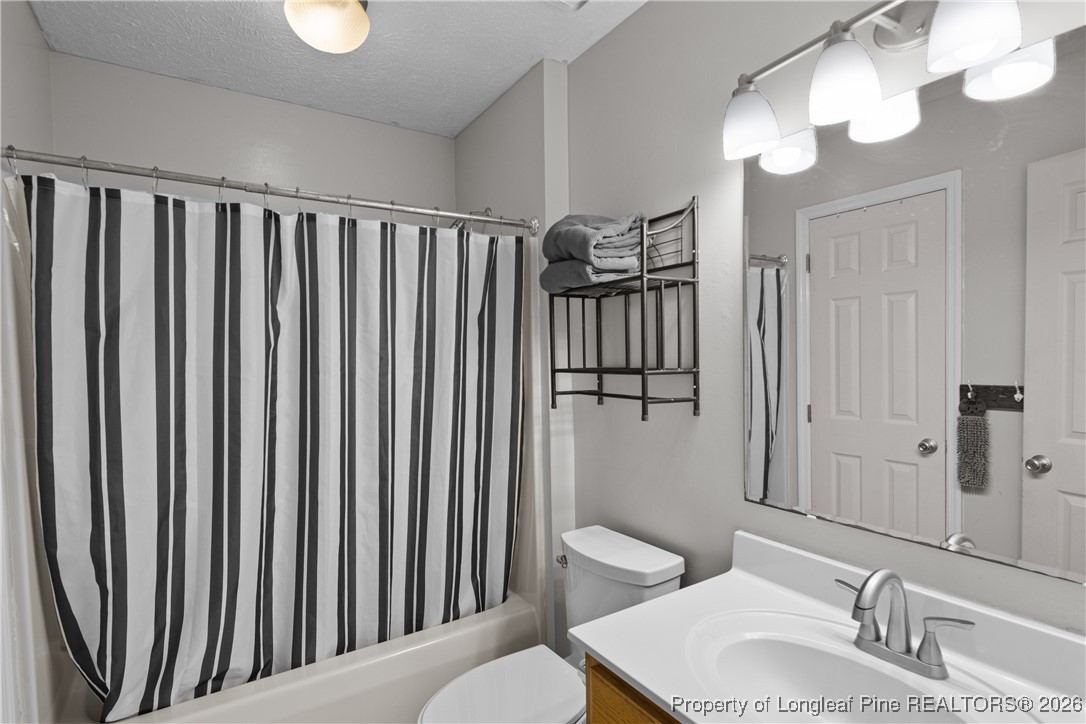 226 Overton Road Raeford, NC 28376 - Photo 14 of 24 a bathroom with a sink a toilet and shower