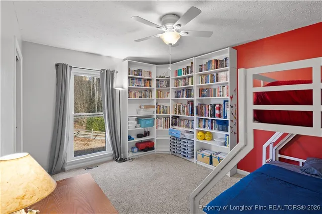 a living room with lots of furniture and a book shelf