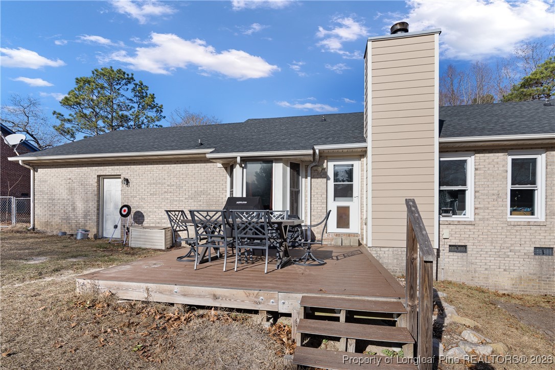 226 Overton Road Raeford, NC 28376 - Photo 22 of 24 a view of a patio with table and chairs with wooden floor and fence