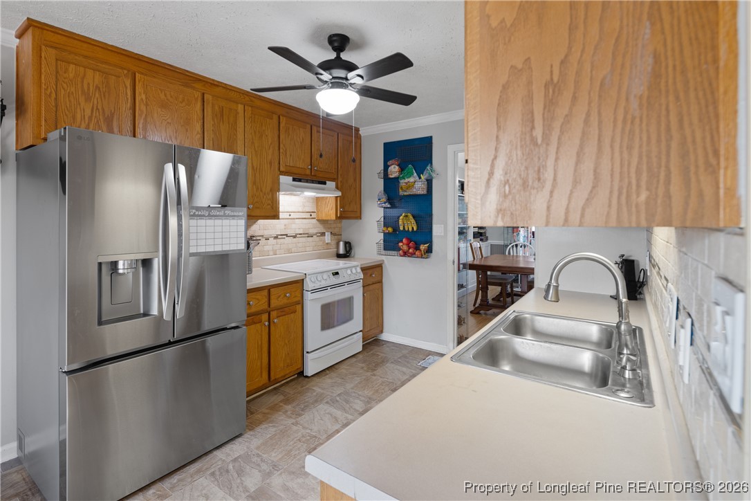 226 Overton Road Raeford, NC 28376 - Photo 7 of 24 a kitchen with stainless steel appliances a refrigerator sink and cabinets