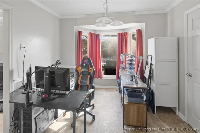 a view of a workspace with furniture and a window