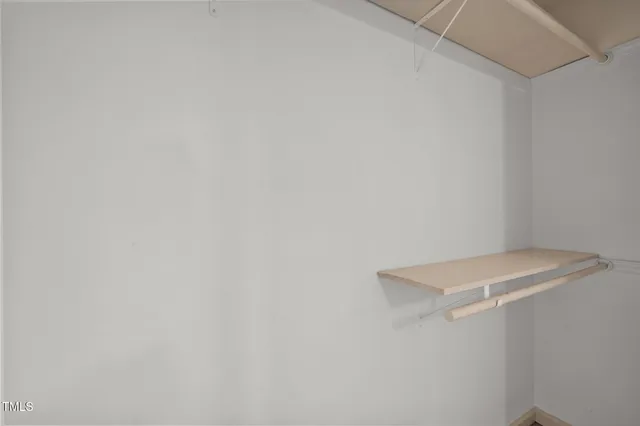 a view of utility room with racks on the wall