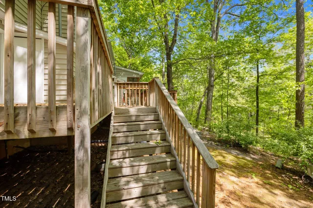 a view of balcony with wooden floor and fence