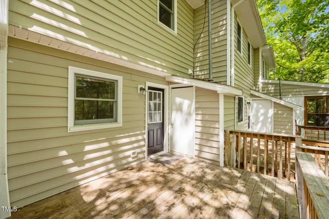 a view of a house with a window and wooden fence