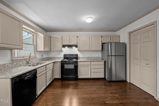 a kitchen with a refrigerator stove and sink