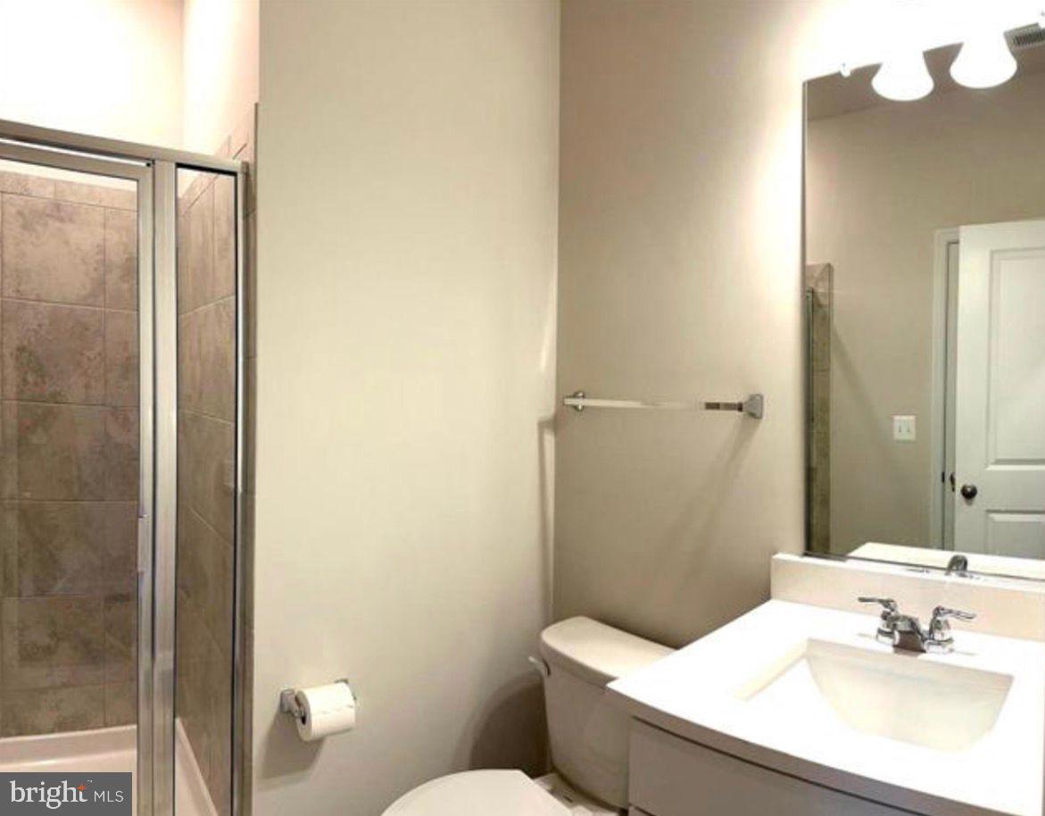 9361 Barnes Loop Manassas, VA 20110 - Photo 16 of 22 a bathroom with a sink and a mirror