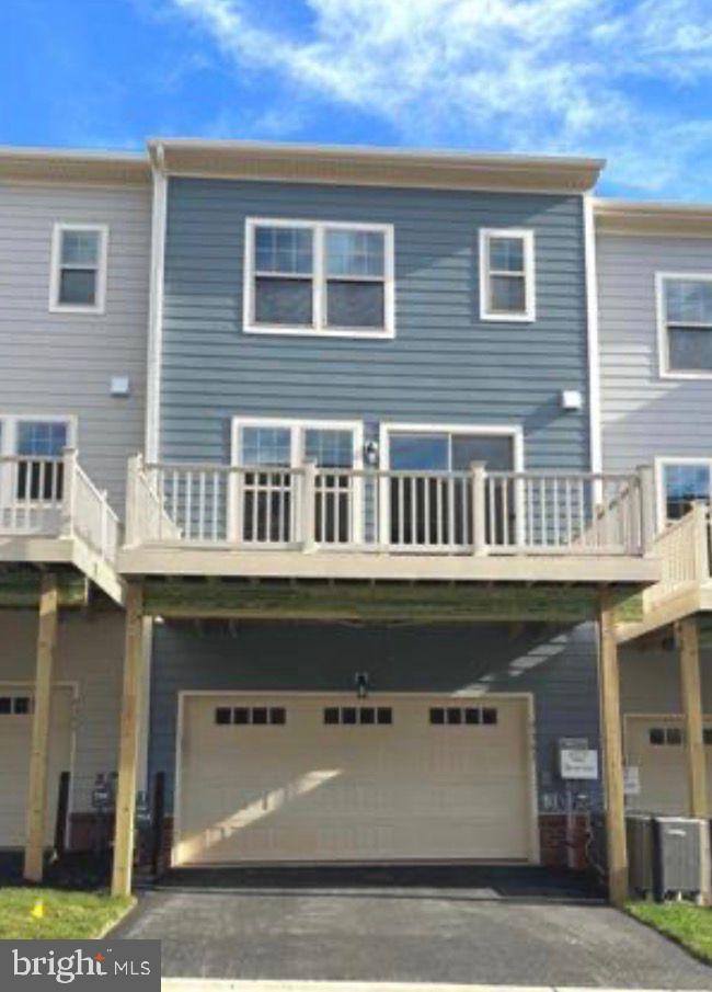 9361 Barnes Loop Manassas, VA 20110 - Photo 18 of 22 a front view of a building with balcony