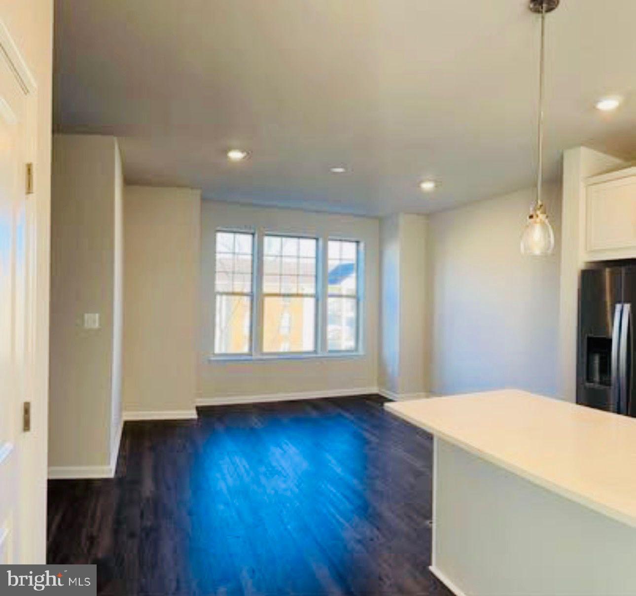 9361 Barnes Loop Manassas, VA 20110 - Photo 4 of 22 a view of a kitchen with wooden floor and a sink