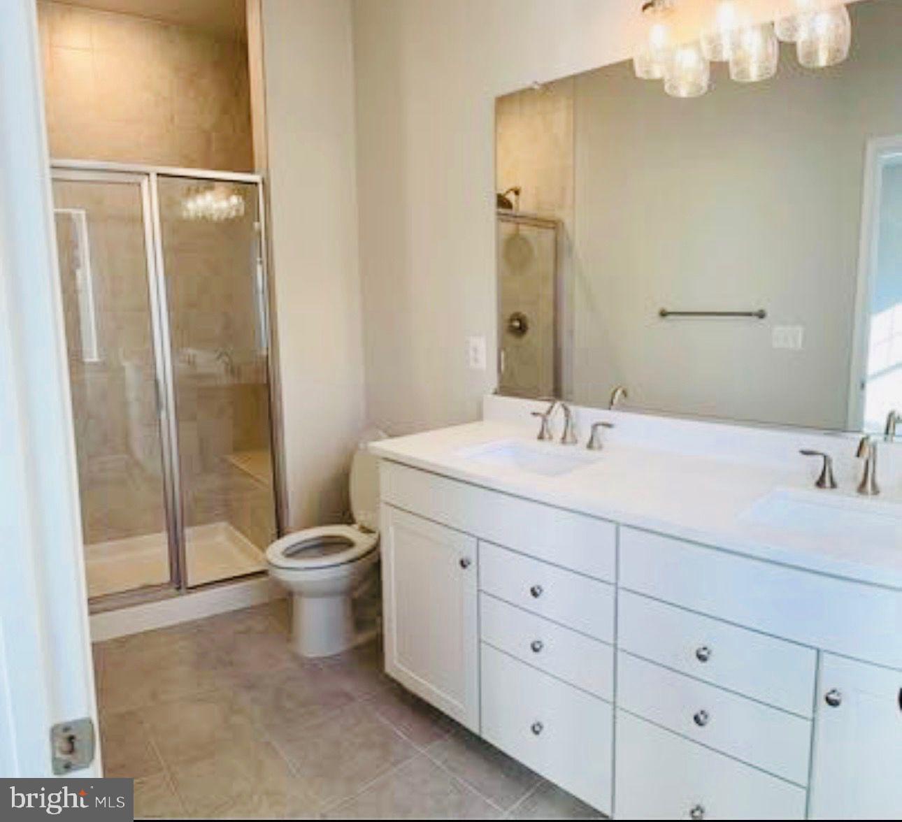 9361 Barnes Loop Manassas, VA 20110 - Photo 10 of 22 a bathroom with a double vanity sink and a mirror