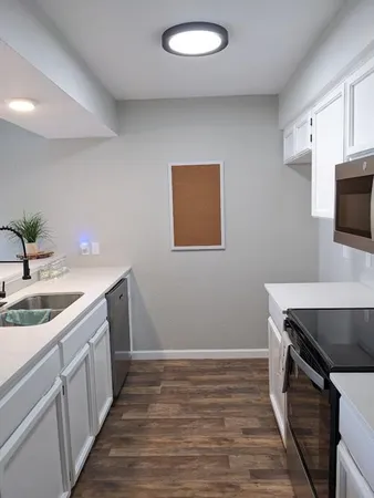 a kitchen with a sink and a stove top oven