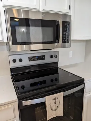 a close view of stove and microwave