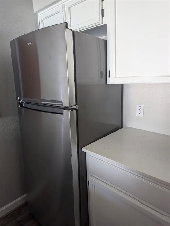 4929 Cedar Pass Drive Corpus Christi, TX 78413 - Photo 14 of 28 a close view of a refrigerator in kitchen and cabinets