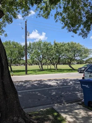 a view of a street with a yard