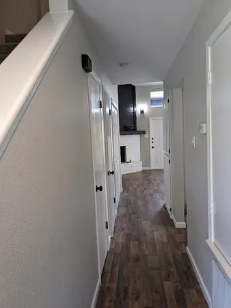 a view of hallway with wooden floor