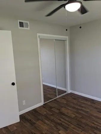 a view of a room with wooden floor