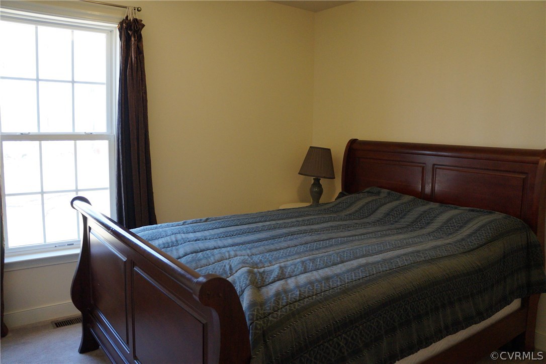 969 Mill Creek Road Meherrin, VA 23954 - Photo 14 of 27 a bed sitting in a bedroom next to a window