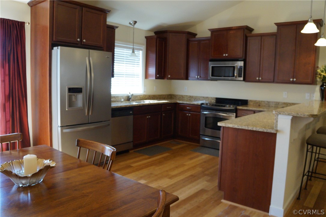 969 Mill Creek Road Meherrin, VA 23954 - Photo 5 of 27 a kitchen with stainless steel appliances granite countertop wooden cabinets a stove top oven a sink and dishwasher
