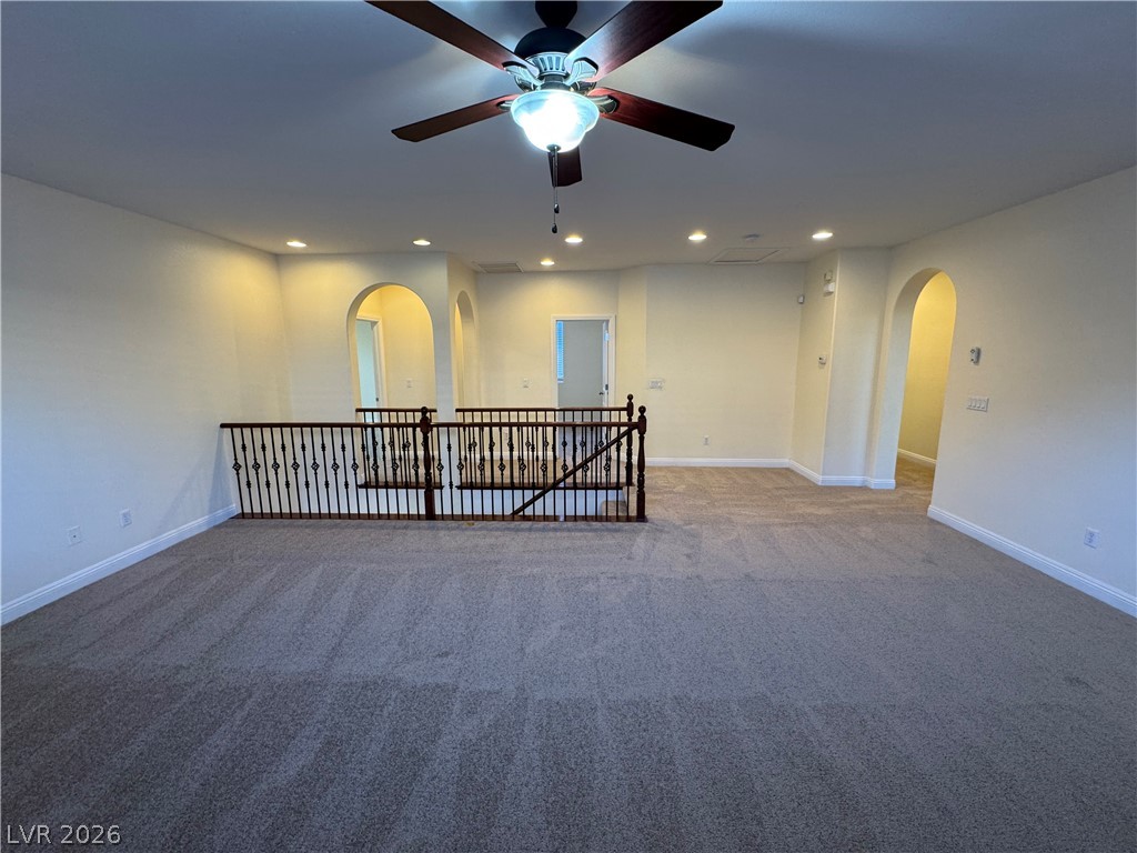 1333 Jamesbury Road Las Vegas, NV 89135 - Photo 27 of 43 An inviting upper-level bonus area offers ample space for various activities, illuminated by recessed lighting and a ceiling fan.