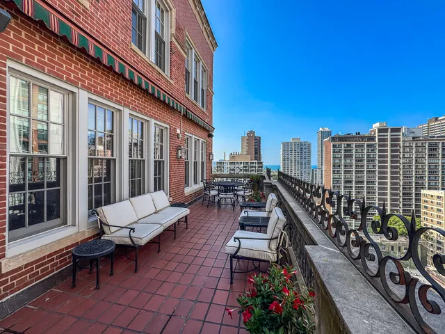 a balcony with outdoor seating and plants