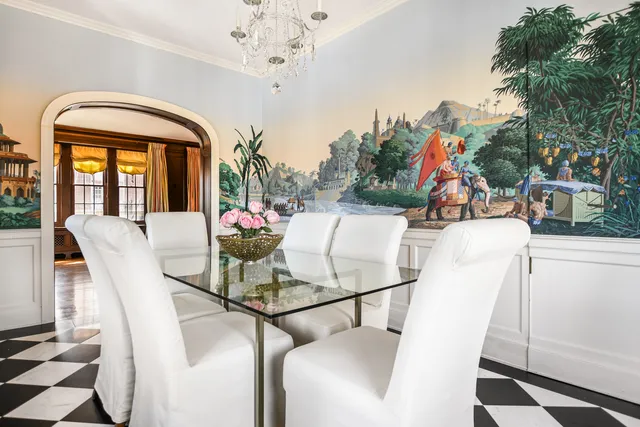 a kitchen with stainless steel appliances a table and chairs in it