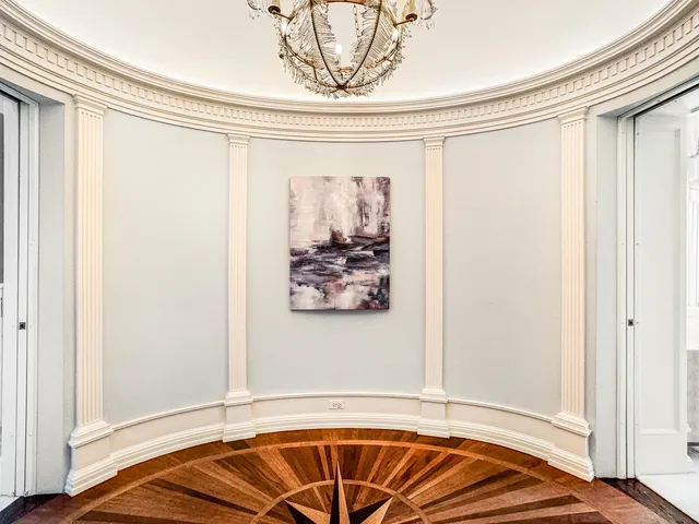 a bedroom with furniture and a large window