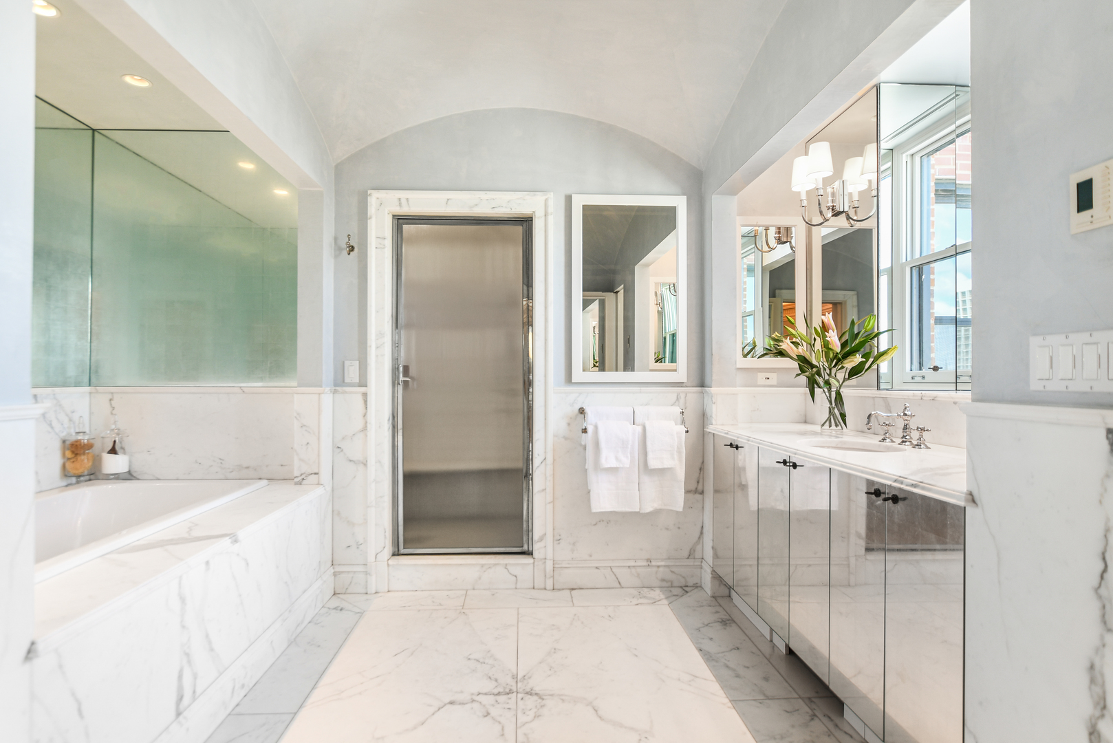 1320 North State Parkway, Unit 1415CD Chicago, IL 60610 - Photo 33 of 51 a bathroom with a double vanity sink a mirror a bathtub and shower