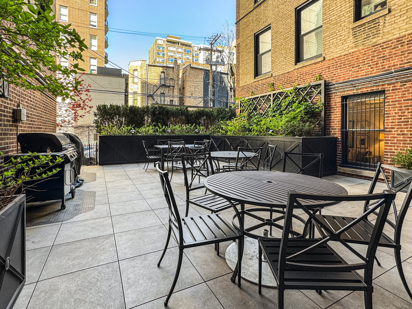 1320 North State Parkway, Unit 1415CD Chicago, IL 60610 - Photo 51 of 51 a view of a patio with table and chairs and potted plants