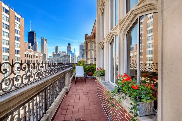 a view of a balcony with potted plants