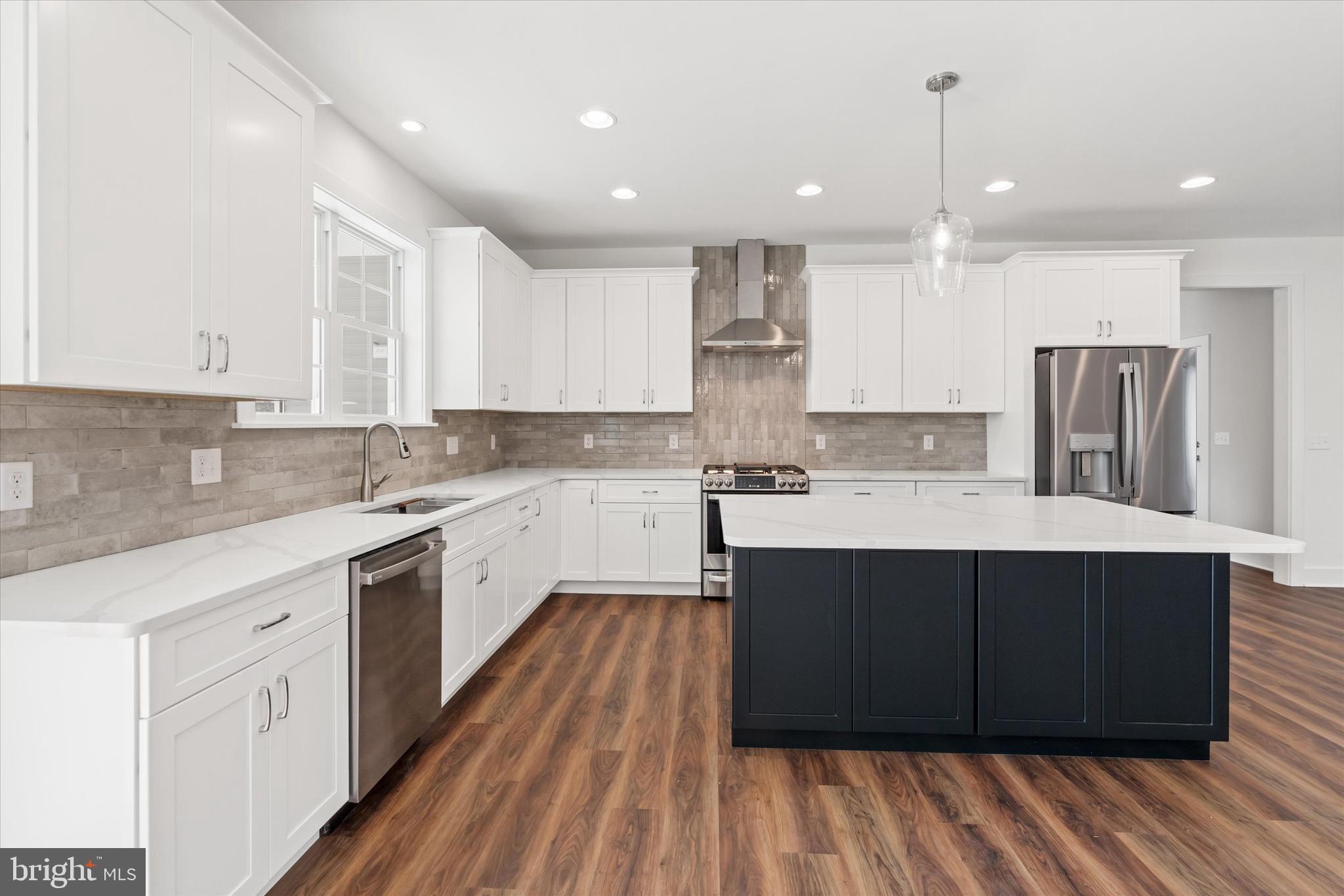 5380 Halltown Road Hartly, DE 19953 - Photo 14 of 45 a large kitchen with stainless steel appliances kitchen island granite countertop wooden cabinets and a sink