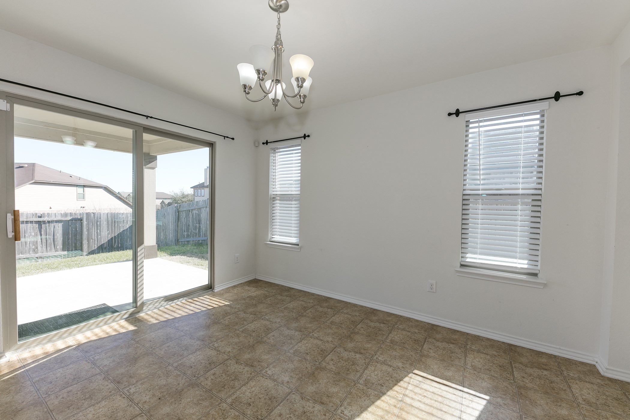 1141 Renaissance Trail Round Rock, TX 78665 - Photo 6 of 23 Ceramic tile flooring extends through this bright dining space, leading to a private patio via sliding glass doors.