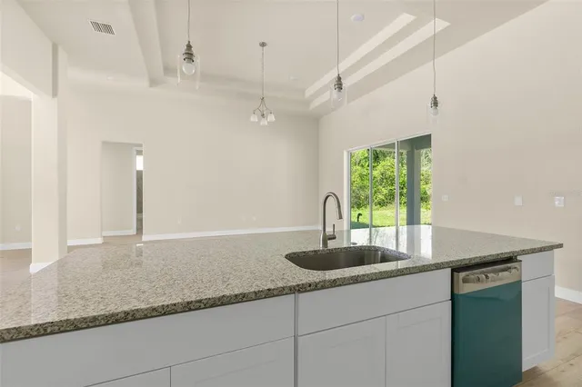 a kitchen with granite countertop a sink and a counter top space