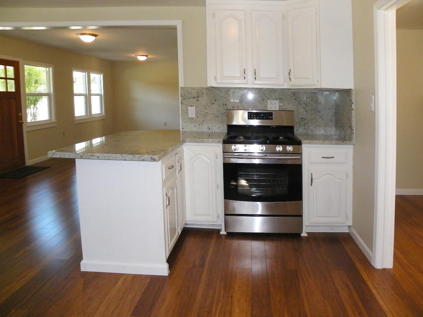 254 Hames Road Corralitos, CA 95076 - Photo 5 of 19 a kitchen with granite countertop a stove and a refrigerator