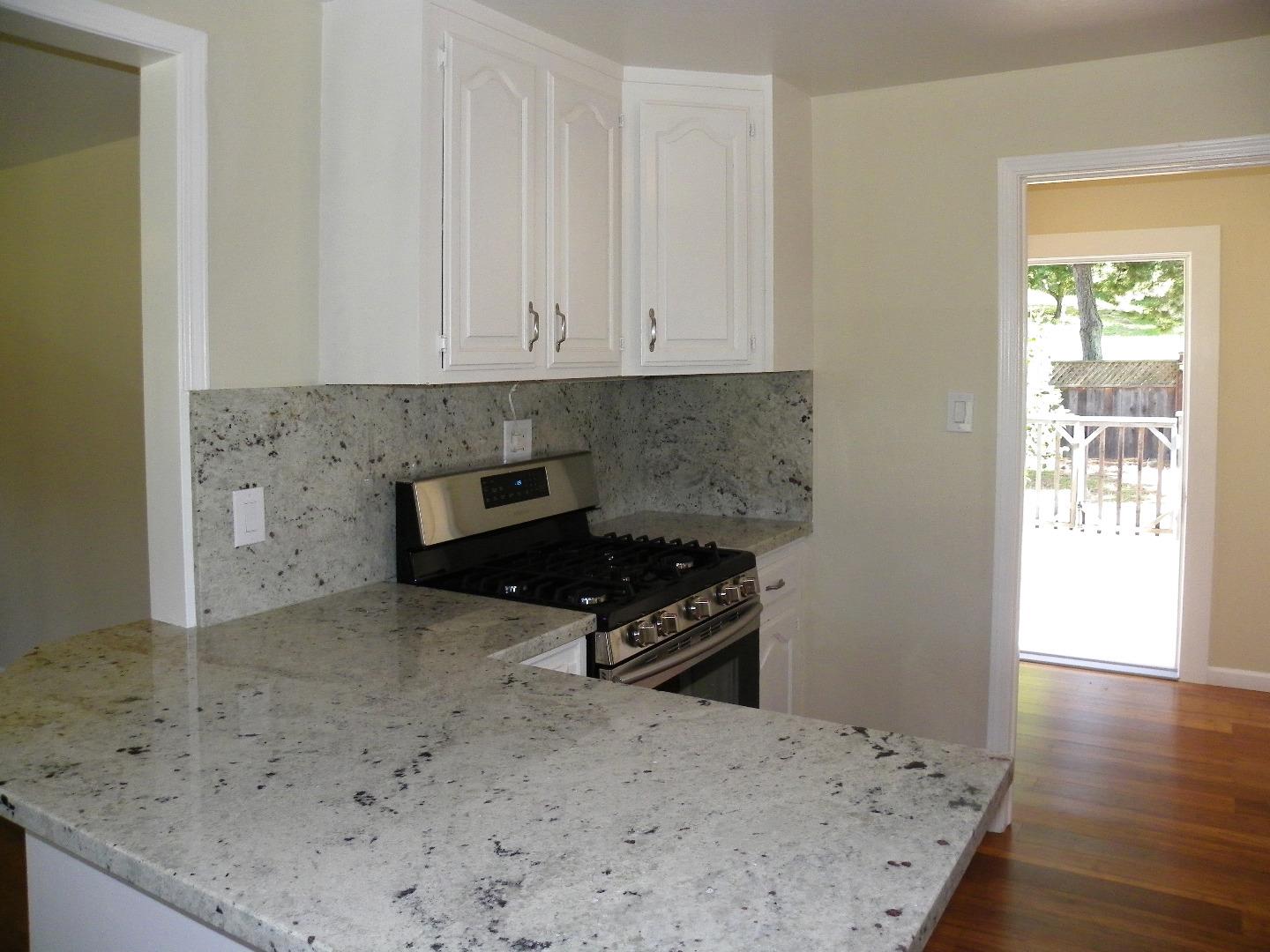 254 Hames Road Corralitos, CA 95076 - Photo 6 of 19 a kitchen with granite countertop a stove a sink and a granite counter tops
