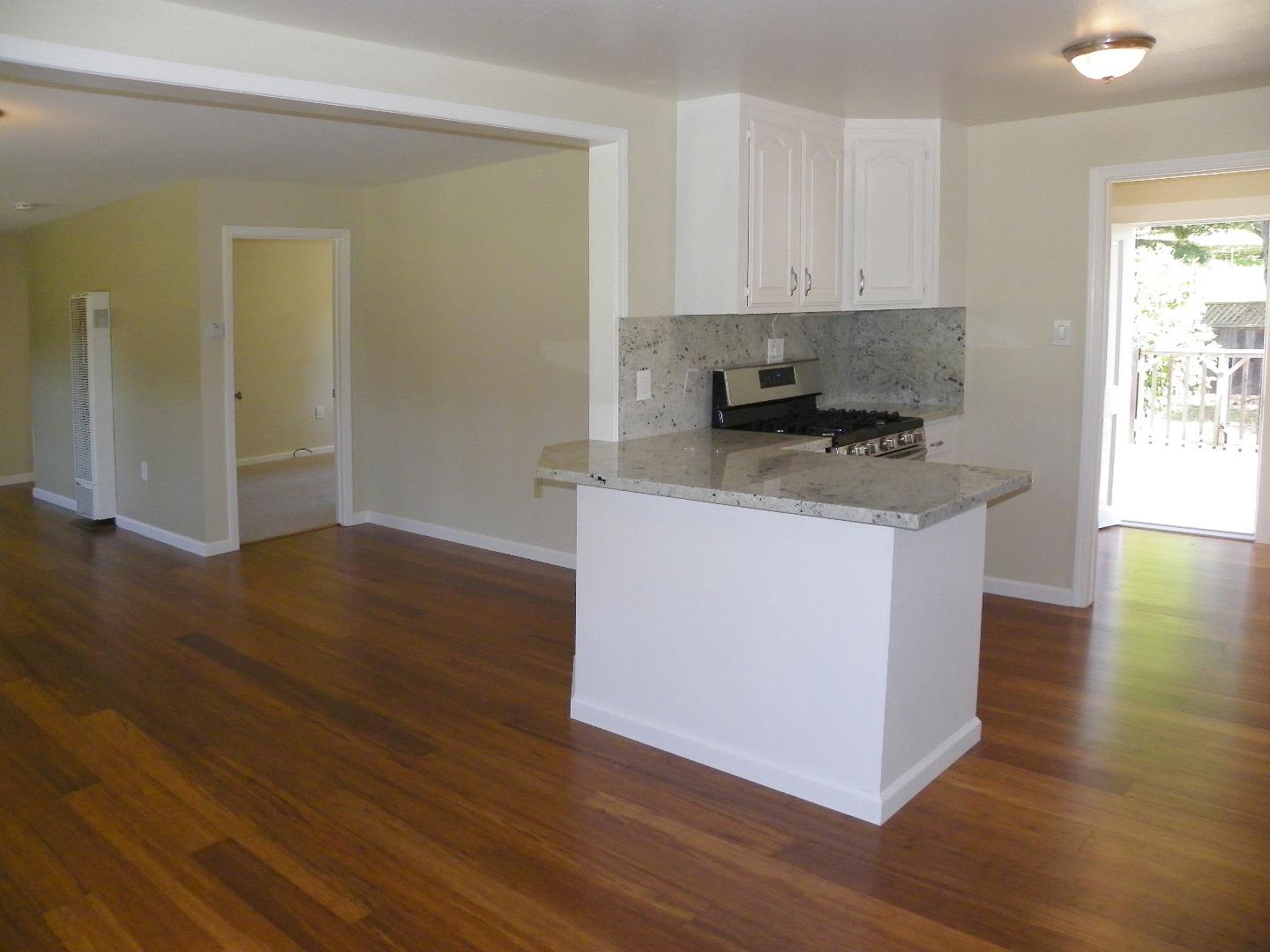 254 Hames Road Corralitos, CA 95076 - Photo 9 of 19 a kitchen with granite countertop a stove and a white refrigerator