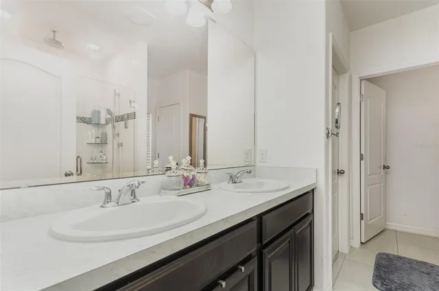a view of kitchen and empty room with wooden floor