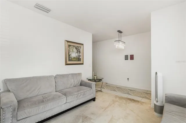 a living room with furniture and a ceiling fan