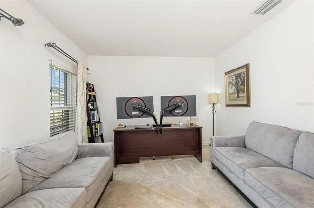 a living room with furniture and painting on the wall