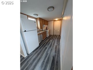 77940 Highway 99, Unit 19 Cottage Grove, OR 97424 - Photo 2 of 5 a view of a refrigerator in kitchen and an empty room