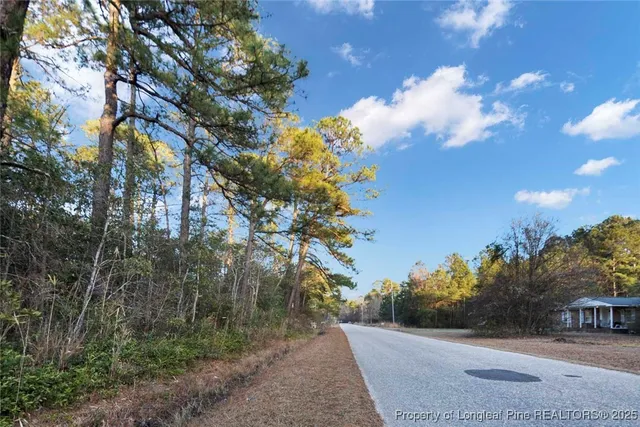 a view of a street with a building in the background