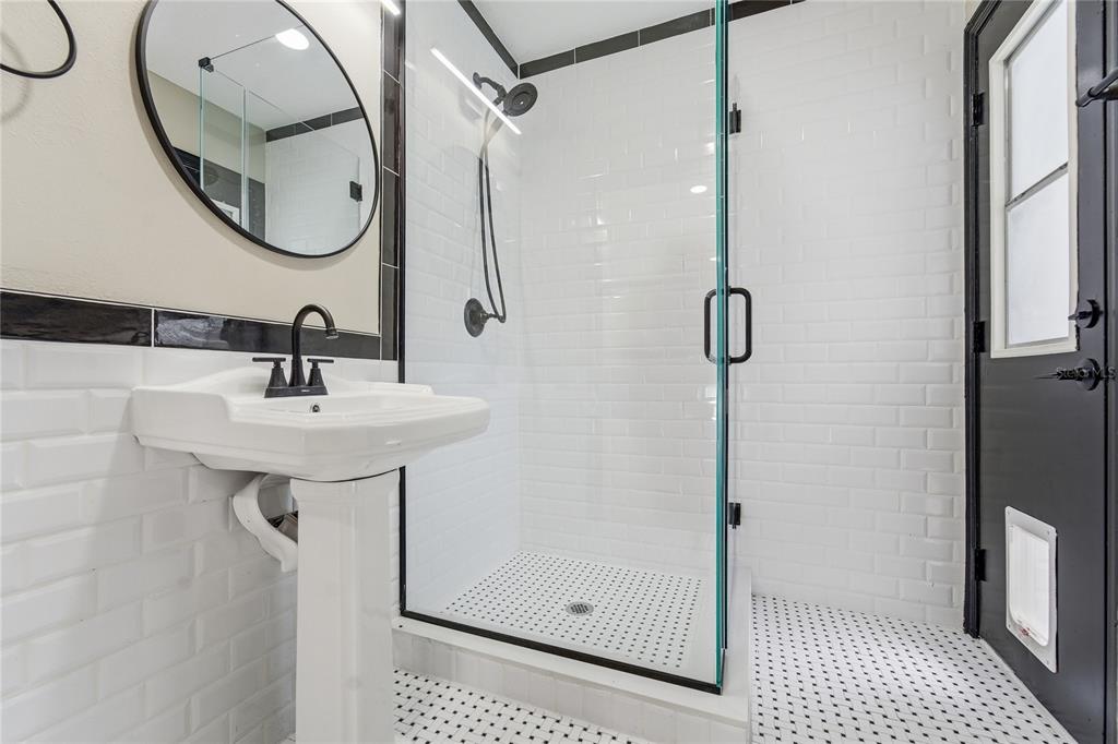 14728 Henson Road Orlando, FL 32832 - Photo 34 of 79 a bathroom with a sink a glass door shower and a mirror