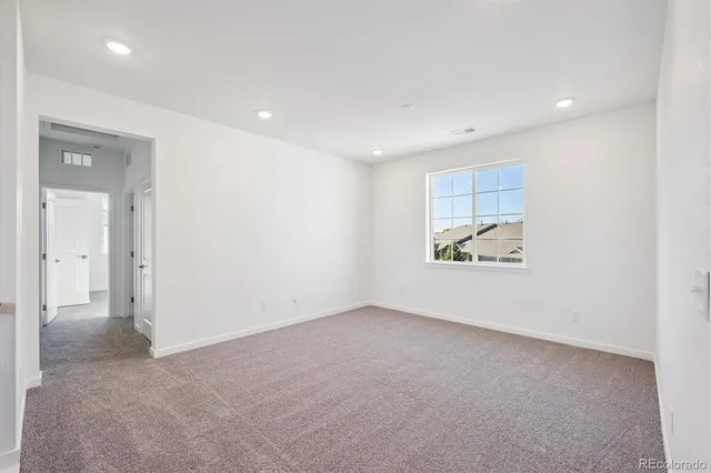 an empty room with windows and entrance