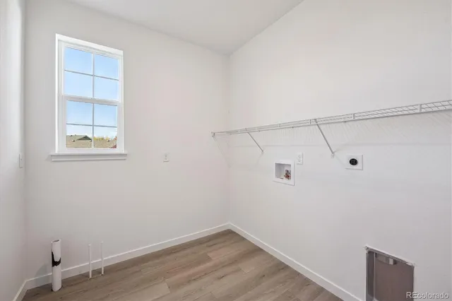 a view of a small space with wooden floor and windows