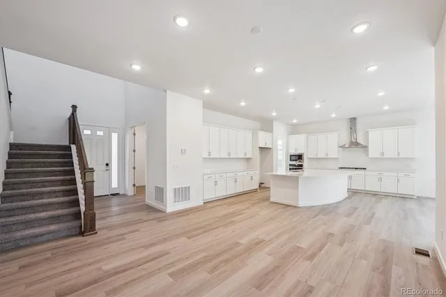 a view of kitchen with cabinets and wooden floor