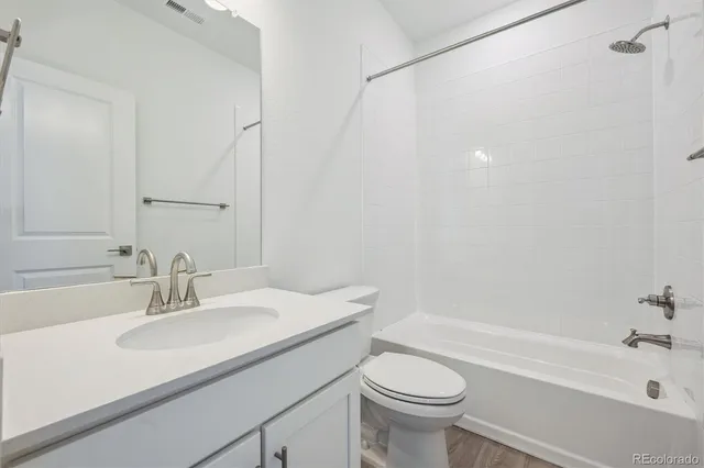a bathroom with a sink a toilet and a bathtub