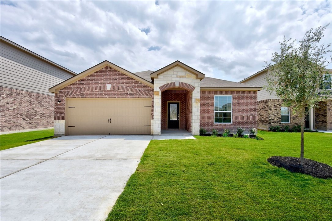 19708 Hubert R Humphrey Road Manor, TX 78653 - Photo 1 of 1 a front view of a house with a yard and garage