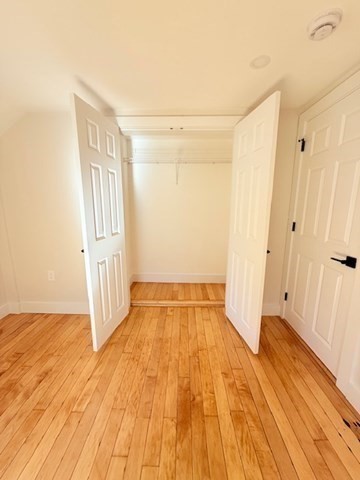 244 Main Street, Unit 2 North Andover, MA 01845 - Photo 23 of 36 a view of an empty room with wooden floor and a window
