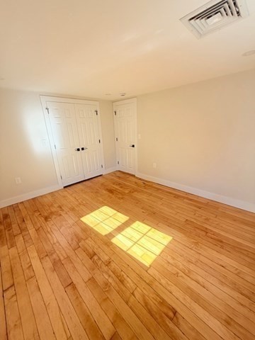 244 Main Street, Unit 2 North Andover, MA 01845 - Photo 24 of 36 an empty room with wooden floor