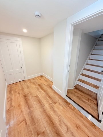 244 Main Street, Unit 2 North Andover, MA 01845 - Photo 33 of 36 a view of a room with wooden floor and stairs
